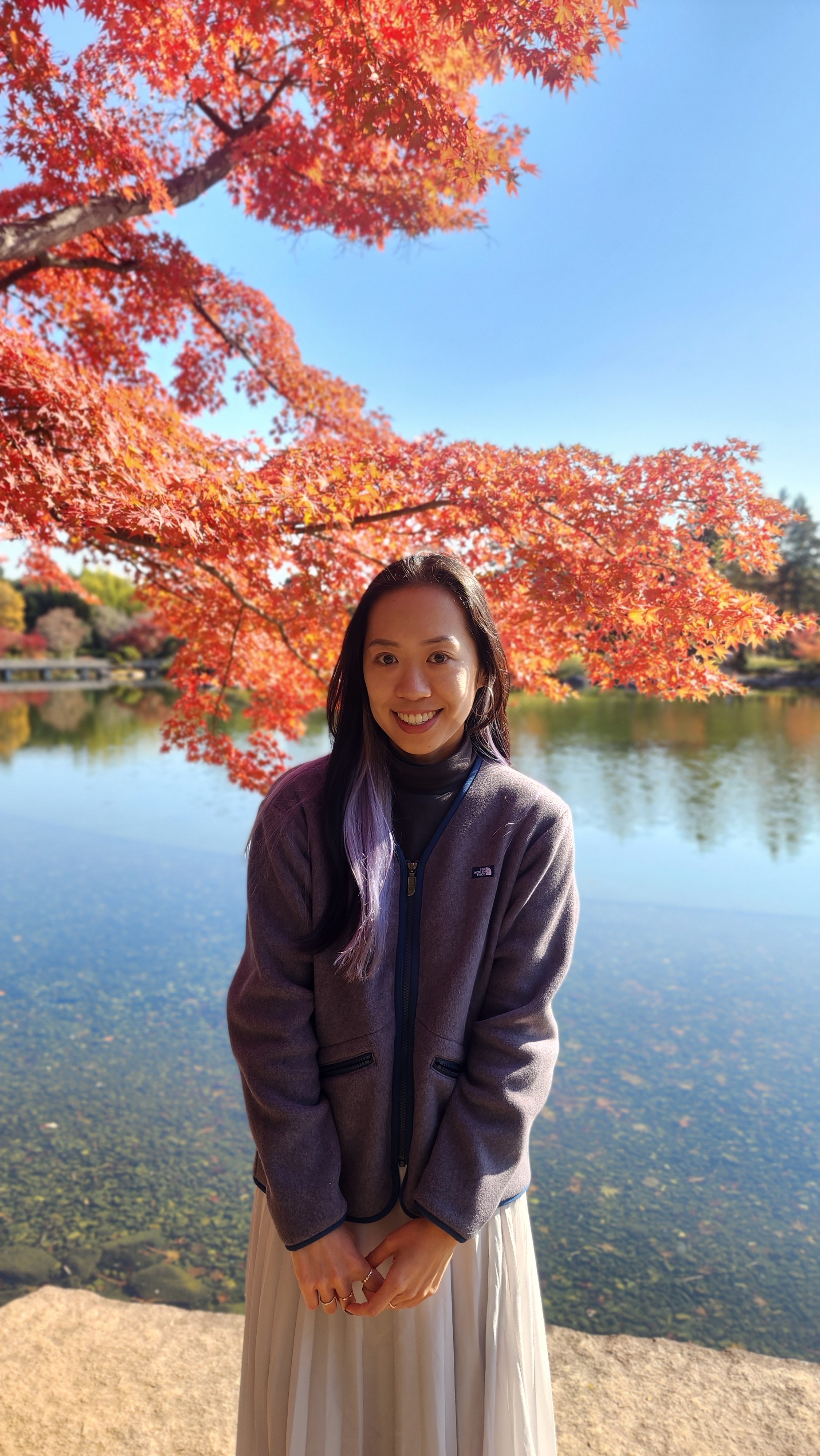 Katsaire standing in front of a cherry blossom tree.