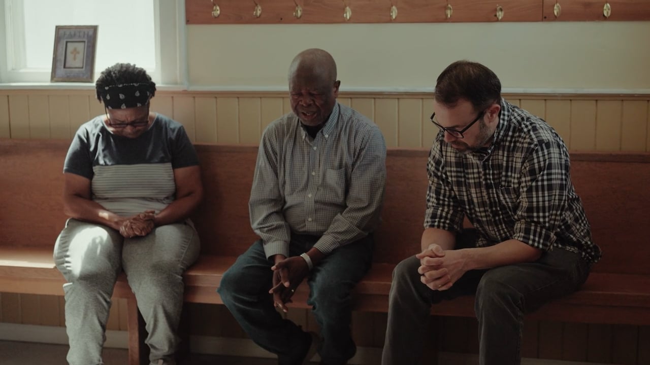 People praying on a bench